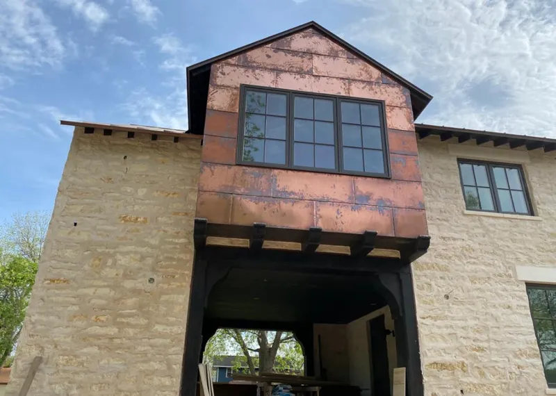 Copper metal panel facade on a stone building for Skylight Installation in Gorham